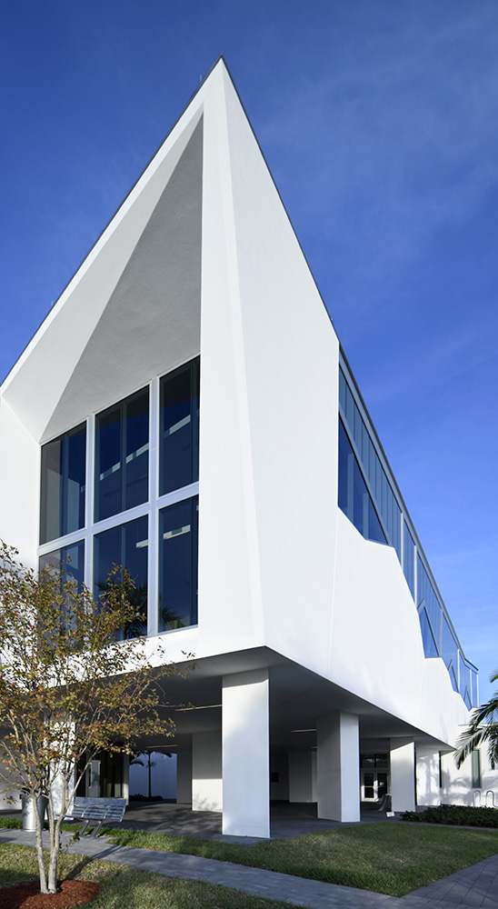 A multi-storied white building serves as the library and cultural center.